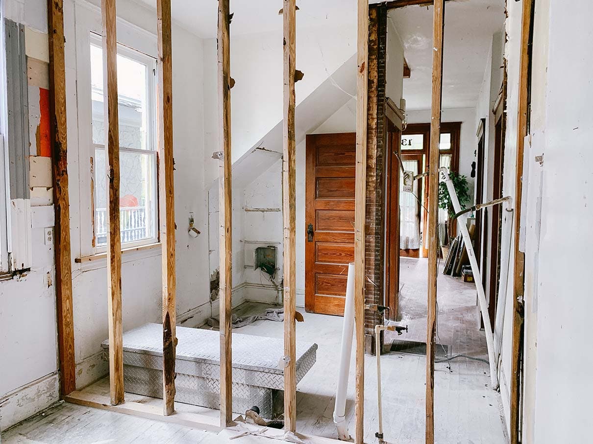 House interior mid-renovation with exposed wall studs